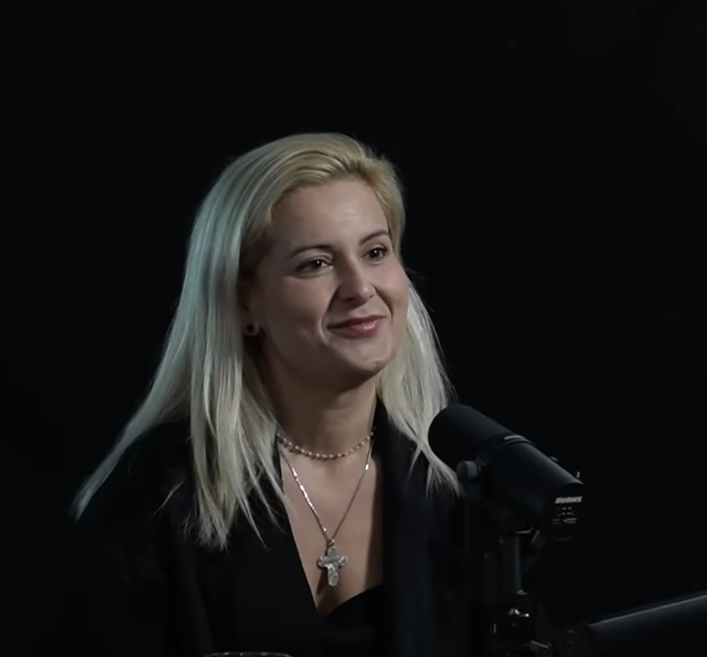 Katerina Todorovski smiling in conversation on a podcast set